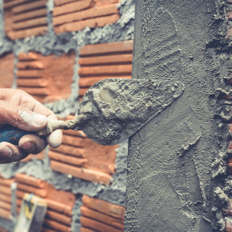 Bricklaying. Construction worker building a brick wall.